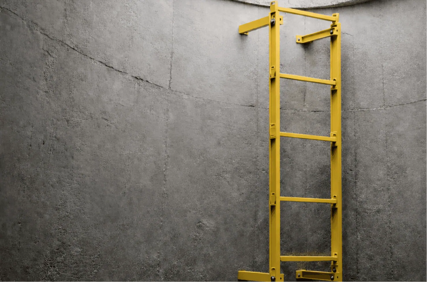 Yellow GRP ladder fixed inside a manhole shaft