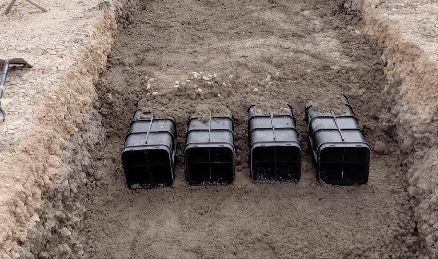 Row of multi-duct cable protection blocks laid in a trench